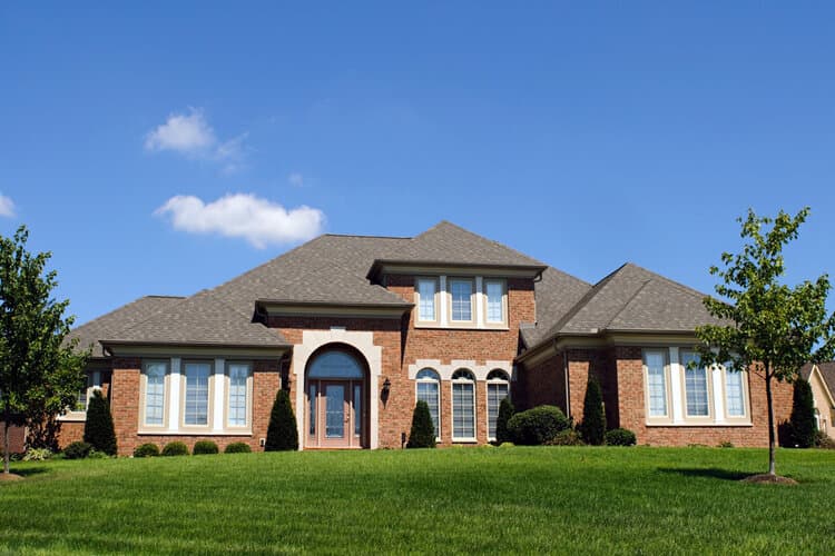 residential home with large front yard and asphalt shingles