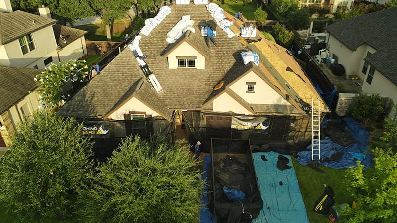 residential roof with shingles being replaced