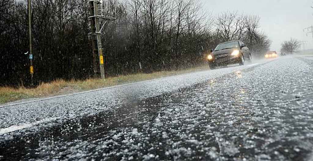 car driving on the road with lots of hail