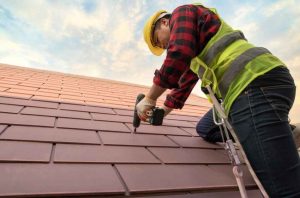 roof repair tech inspecting tile roof with drill