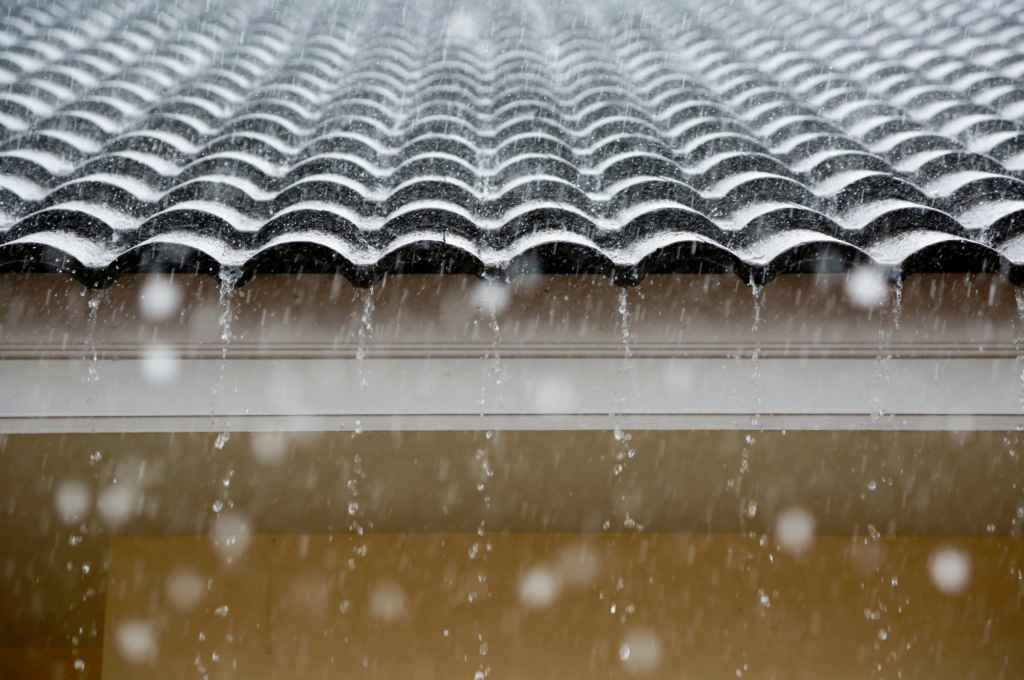 tile roof with rain falling off