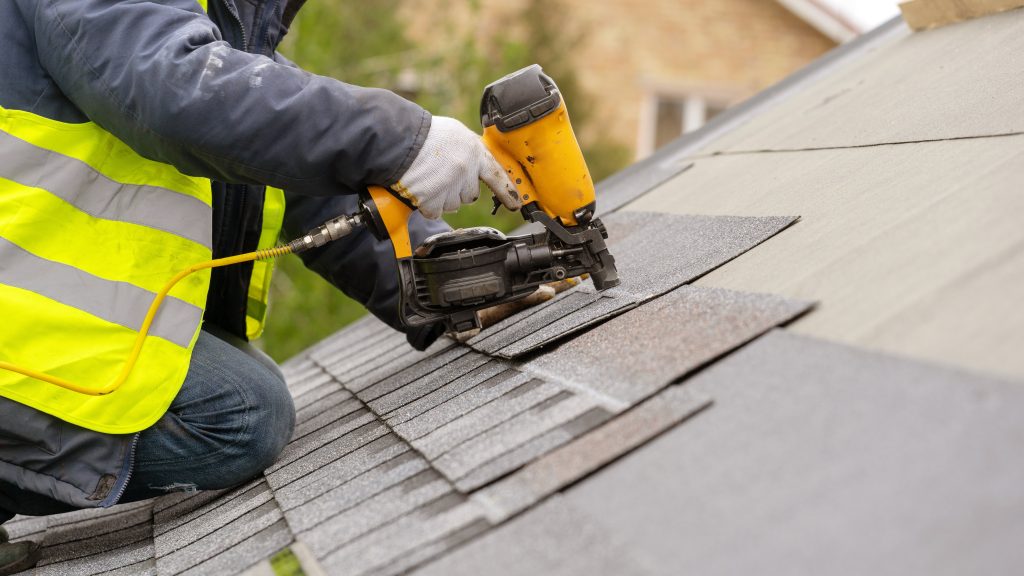 roofing tech with nail gun