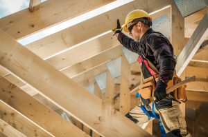 roofing tech standing in roof