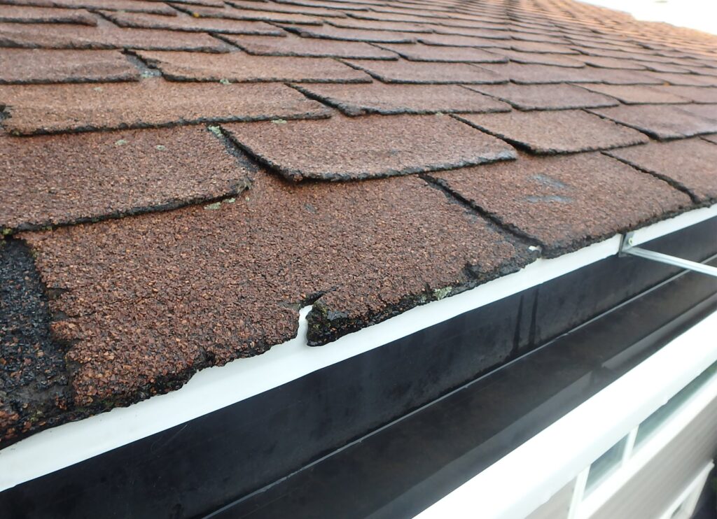 Brown shingle roof with hail damage
