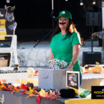 Rhino Roofers team member dressed as Luigi hosting games at the Kinetic Kids Halloween Family Unite Night in Helotes, Texas.