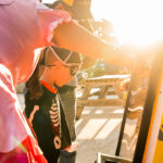 Child dressed as a pirate plays a Halloween game at the Rhino Roofers booth during the Kinetic Kids Family Unite Night event.