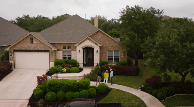 Rhino Roofers expert reviewing inspection findings outside with a homeowner